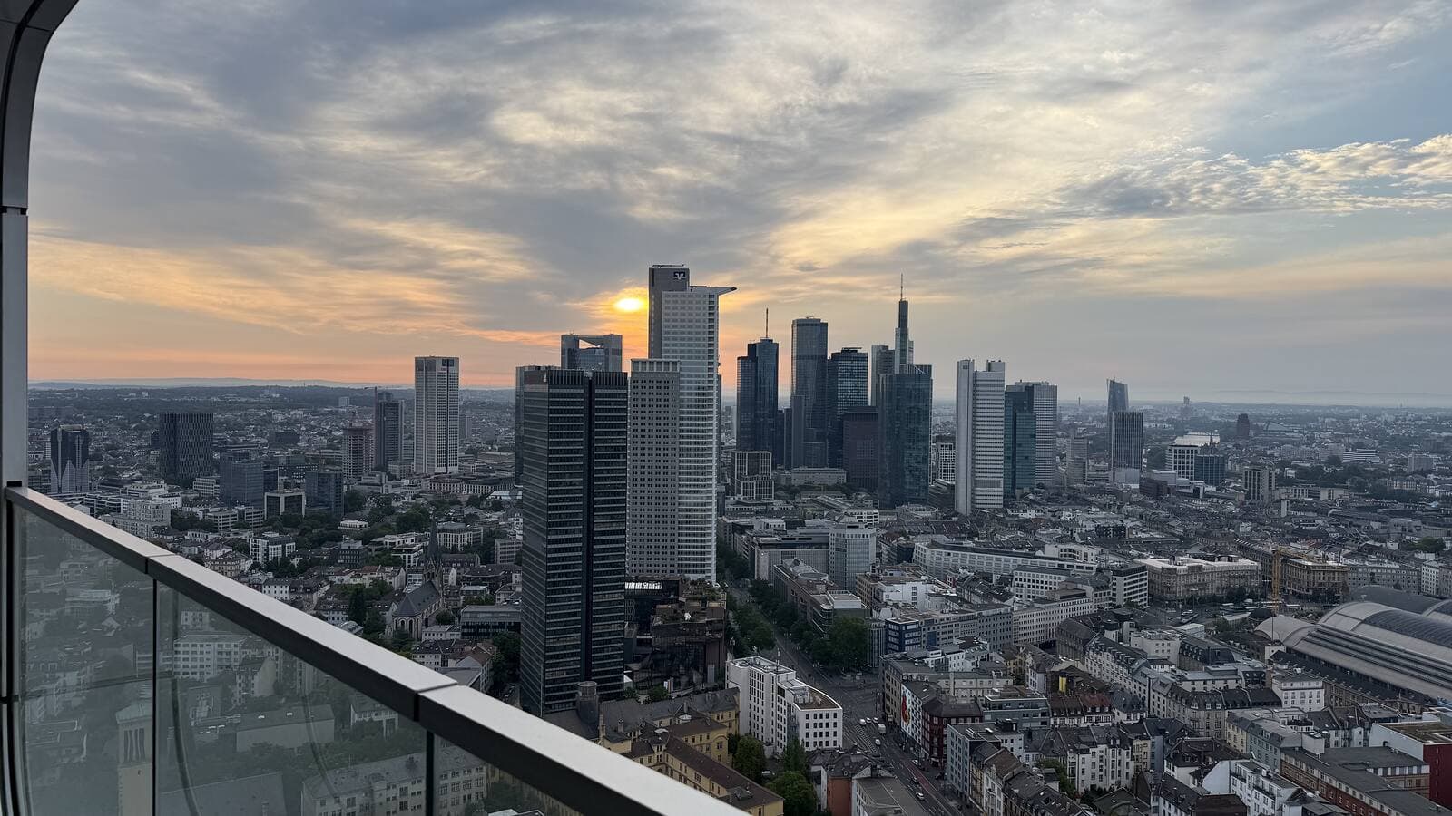 Sunset behind the Frankfurt skyline, seen from a high-floor balcony at Grand Tower