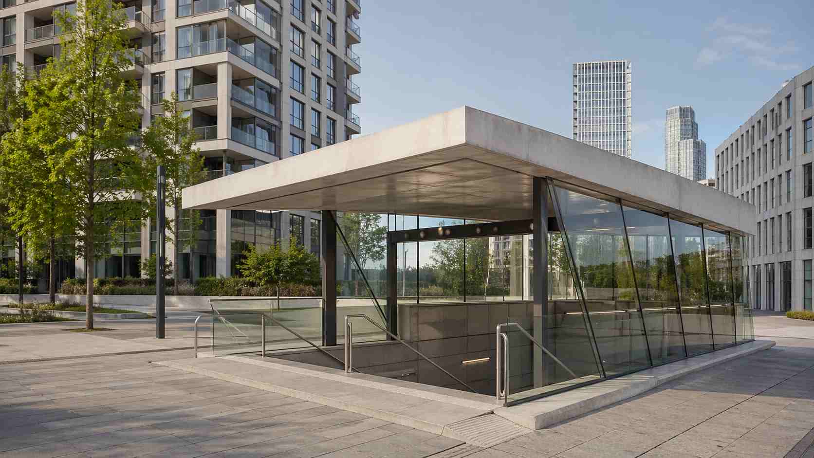 Modern glass and concrete U-Bahn station entrance beside residential towers in Frankfurt's Europaviertel