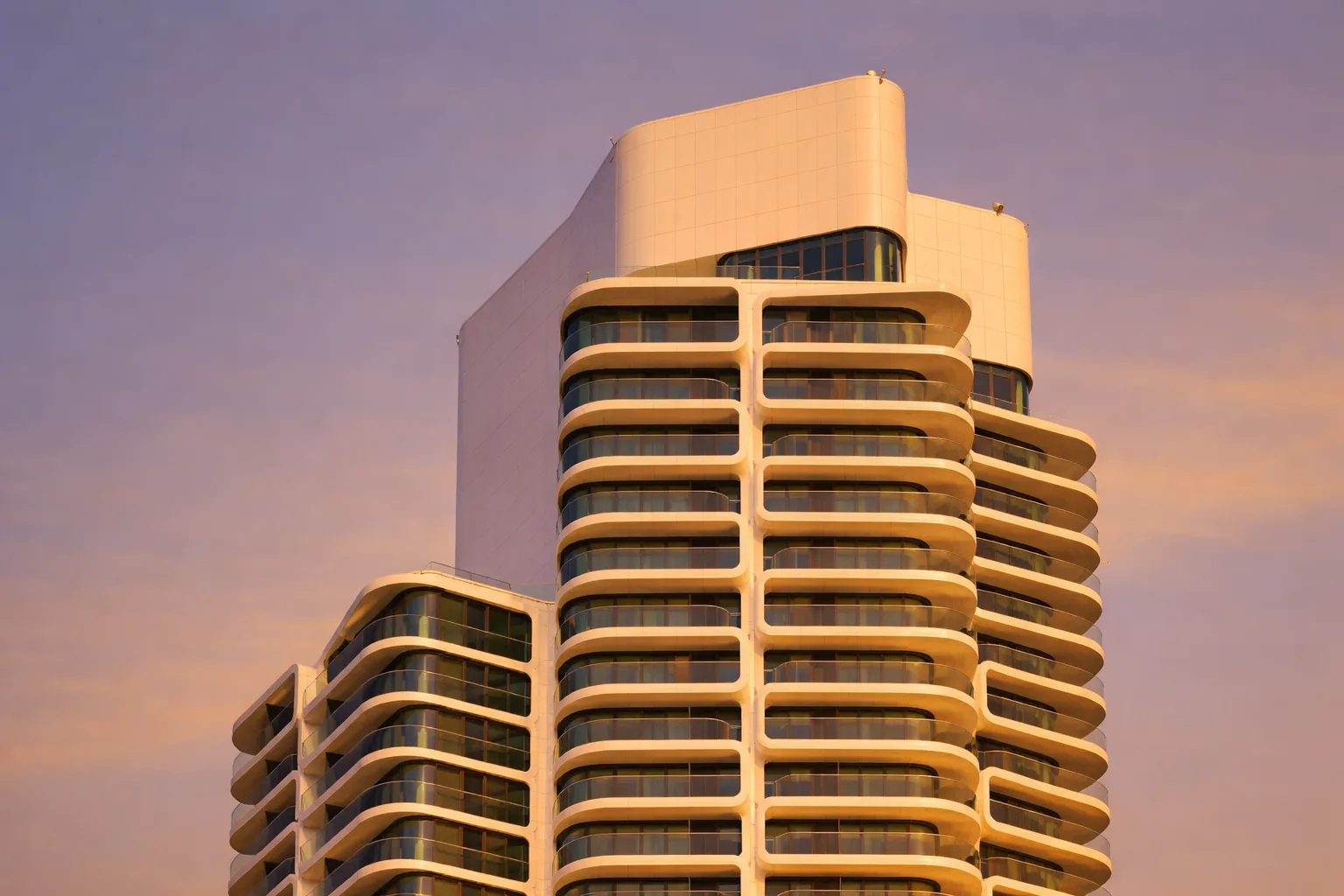 Grand Tower Frankfurt — the upper floors and crown at golden hour, honeycomb balconies catching the last light